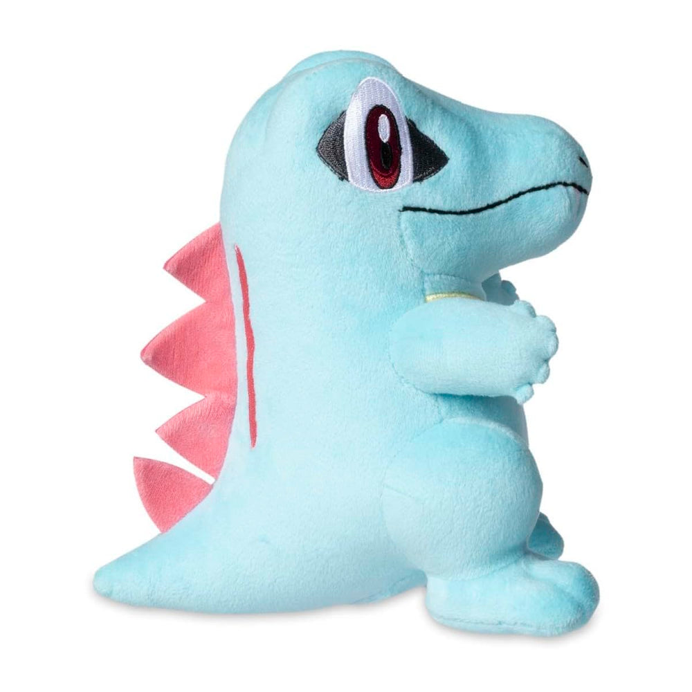 Pokemon Center Totodile plush texture close-up shows zigzag back spikes and felt teeth.