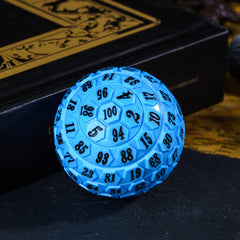 Poludie 100‑sided die on tabletop, ready for RPG gameplay.