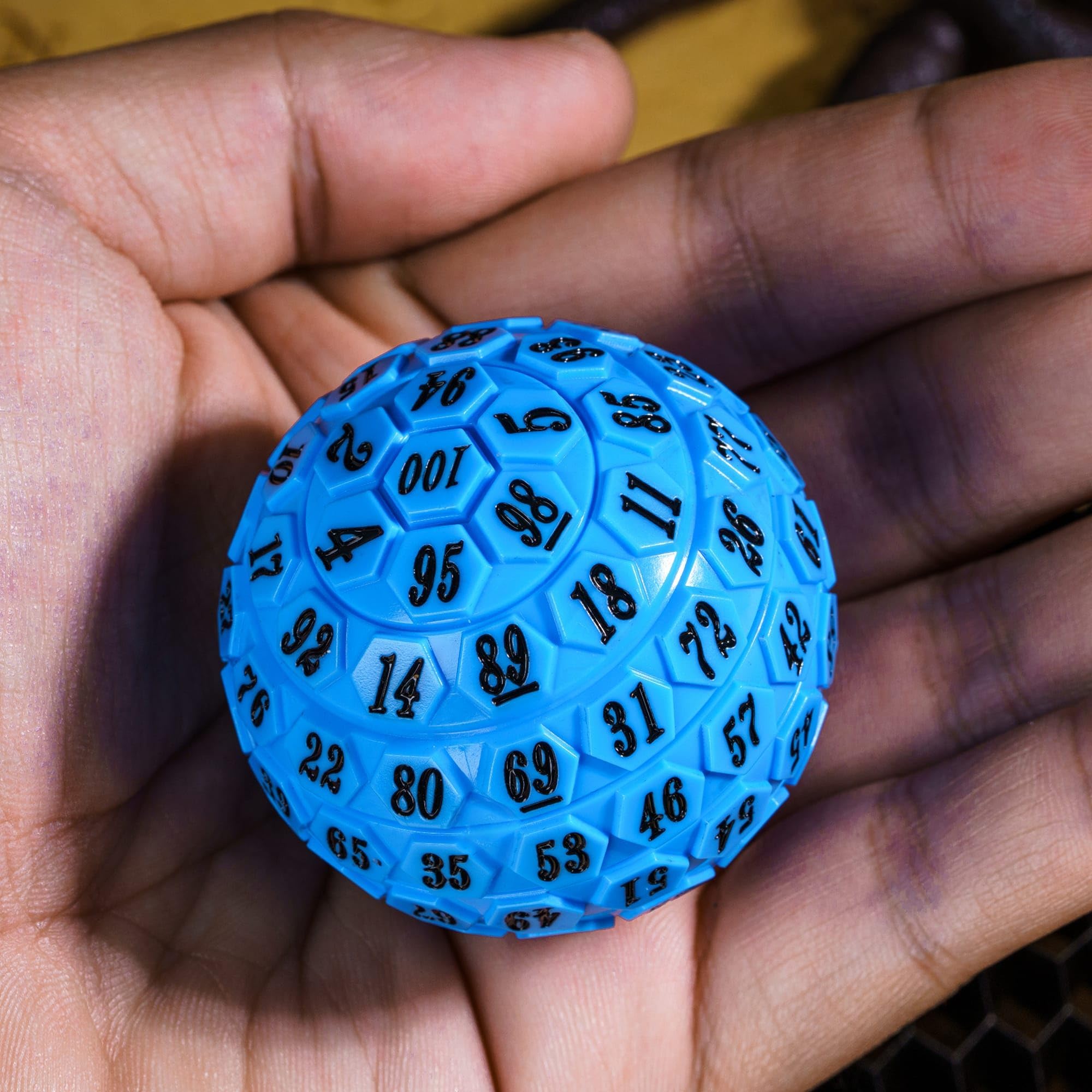 Poludie 100‑sided die close-up with engraved numbers, easy to read.