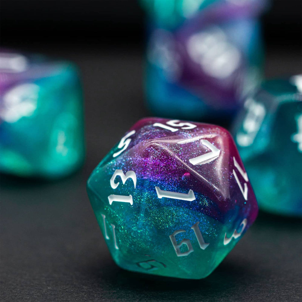 Poludie Rose Blue Glitter Dice Set side view highlights sparkling edges for dramatic table presence.
