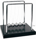 PowerTRC Newtons Cradle balance balls showing momentum transfer on a stylish desk.
