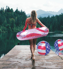 POZA USA flag inflatable float tube in use during sunlit water activity.