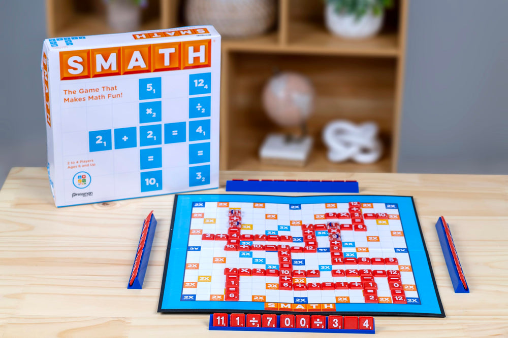 Two players strategize on a colorful Smath board during family game night.