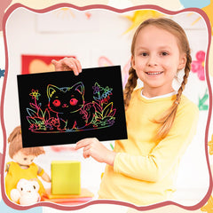Child enjoys scratch art activity, turning lines into colorful patterns with Prudiut.