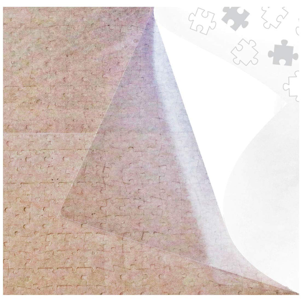 Puzzle EZ clear glue sheets four-pack laid over a finished puzzle for easy preservation.