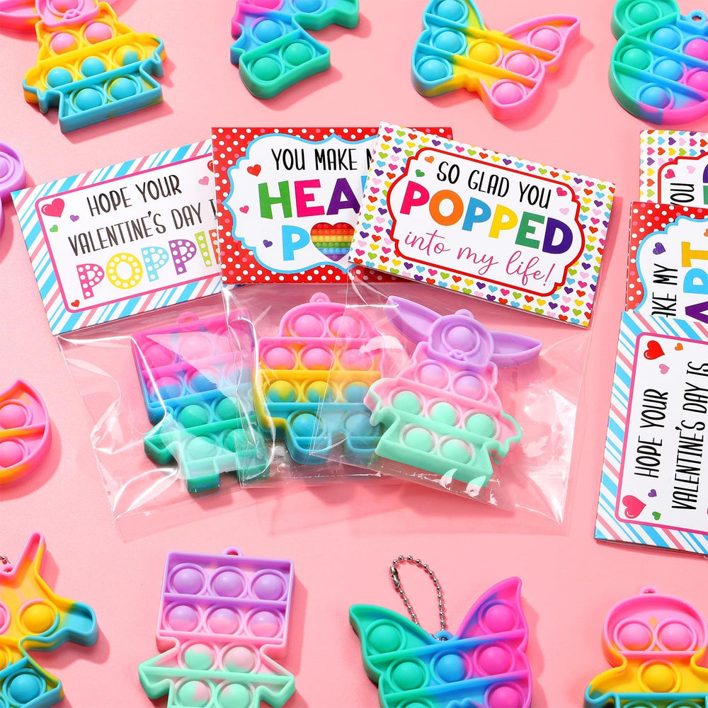 Qinline three gift card designs displayed alongside fidget toys