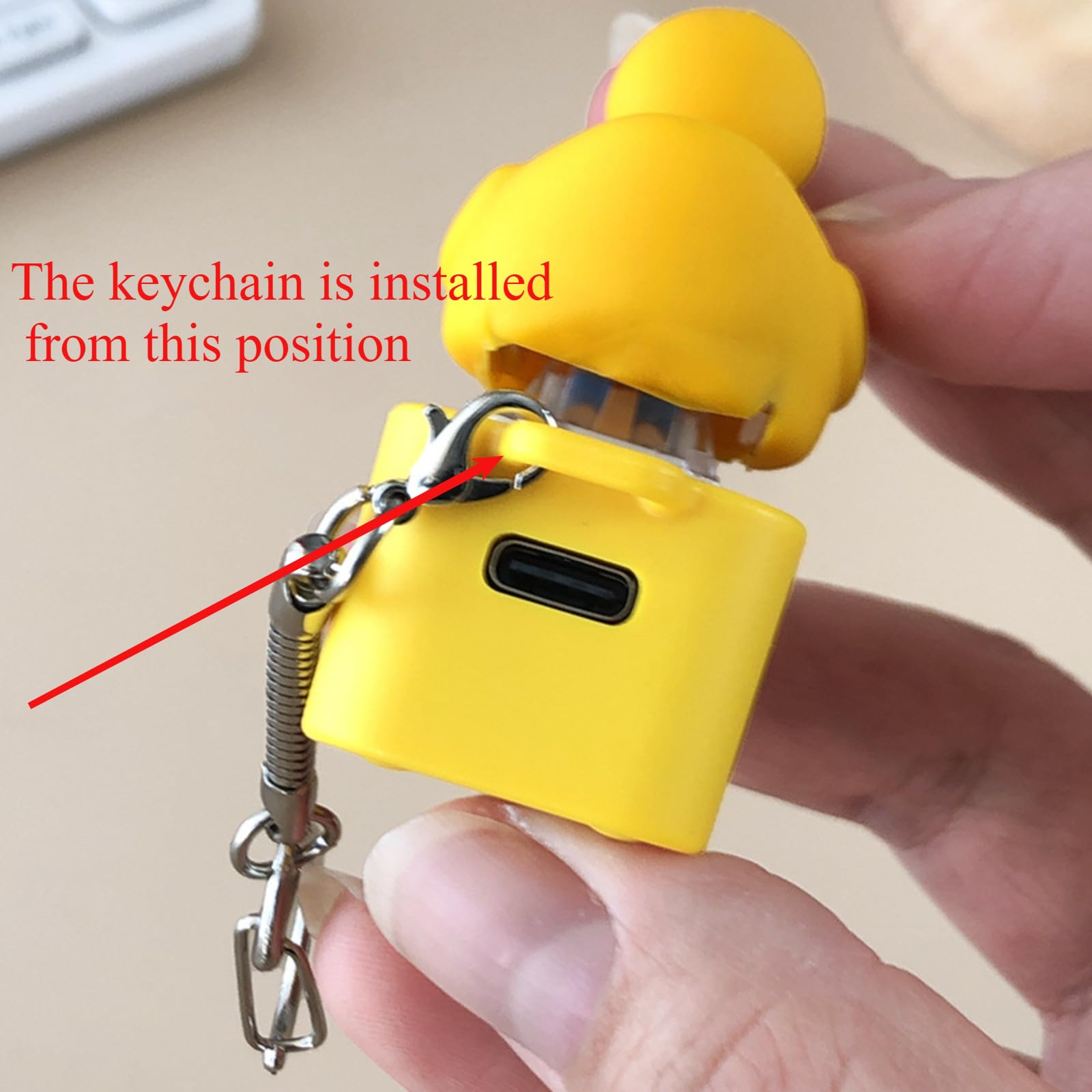 Quacking Duck keychain on desk used as portable sensory companion.