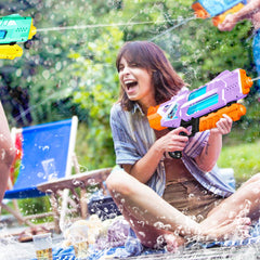 Quanquer water guns at a pool party with vibrant purple and green colors.