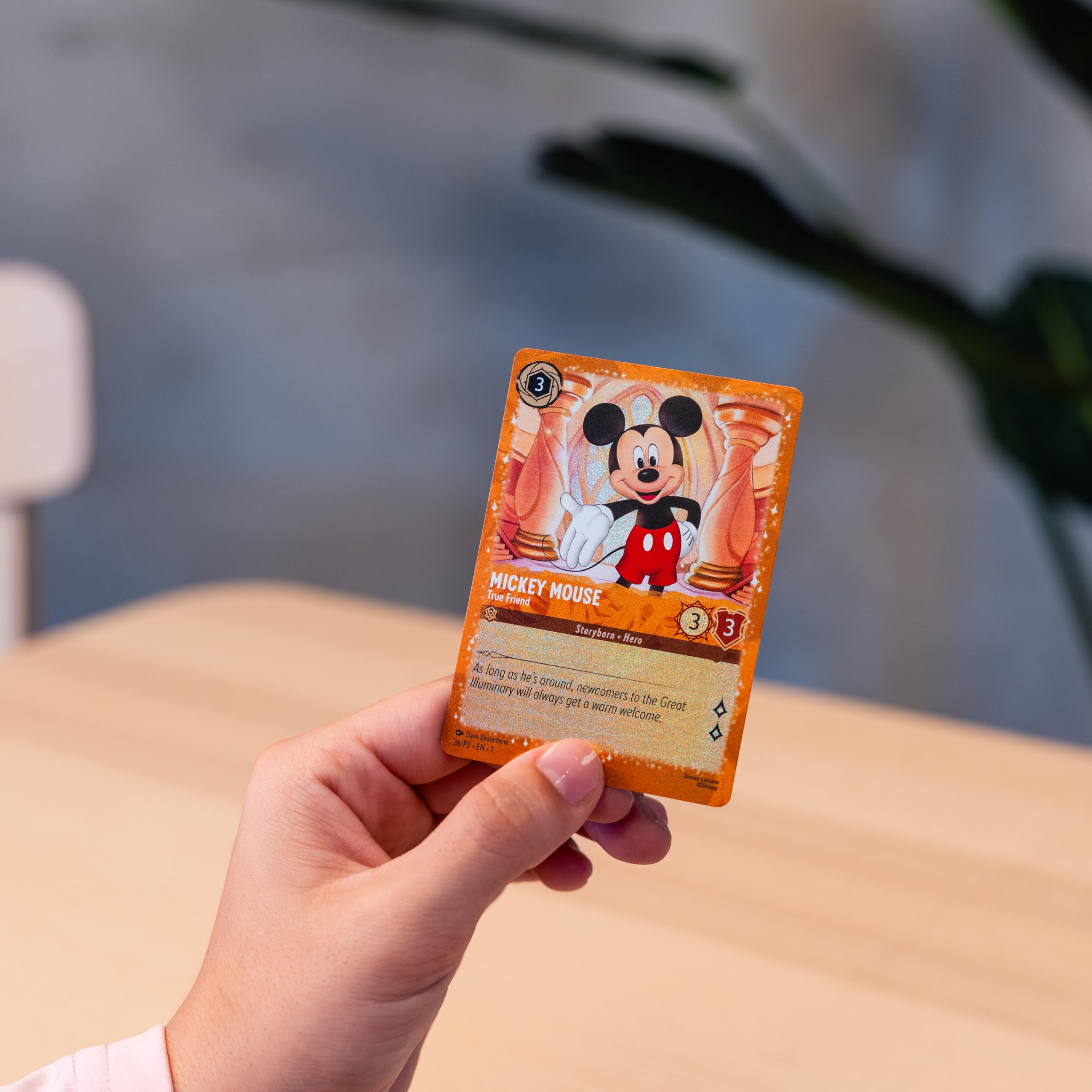 Ravensburger Disney Lorcana emerald glimmers closeup—vivid details catch the eye.