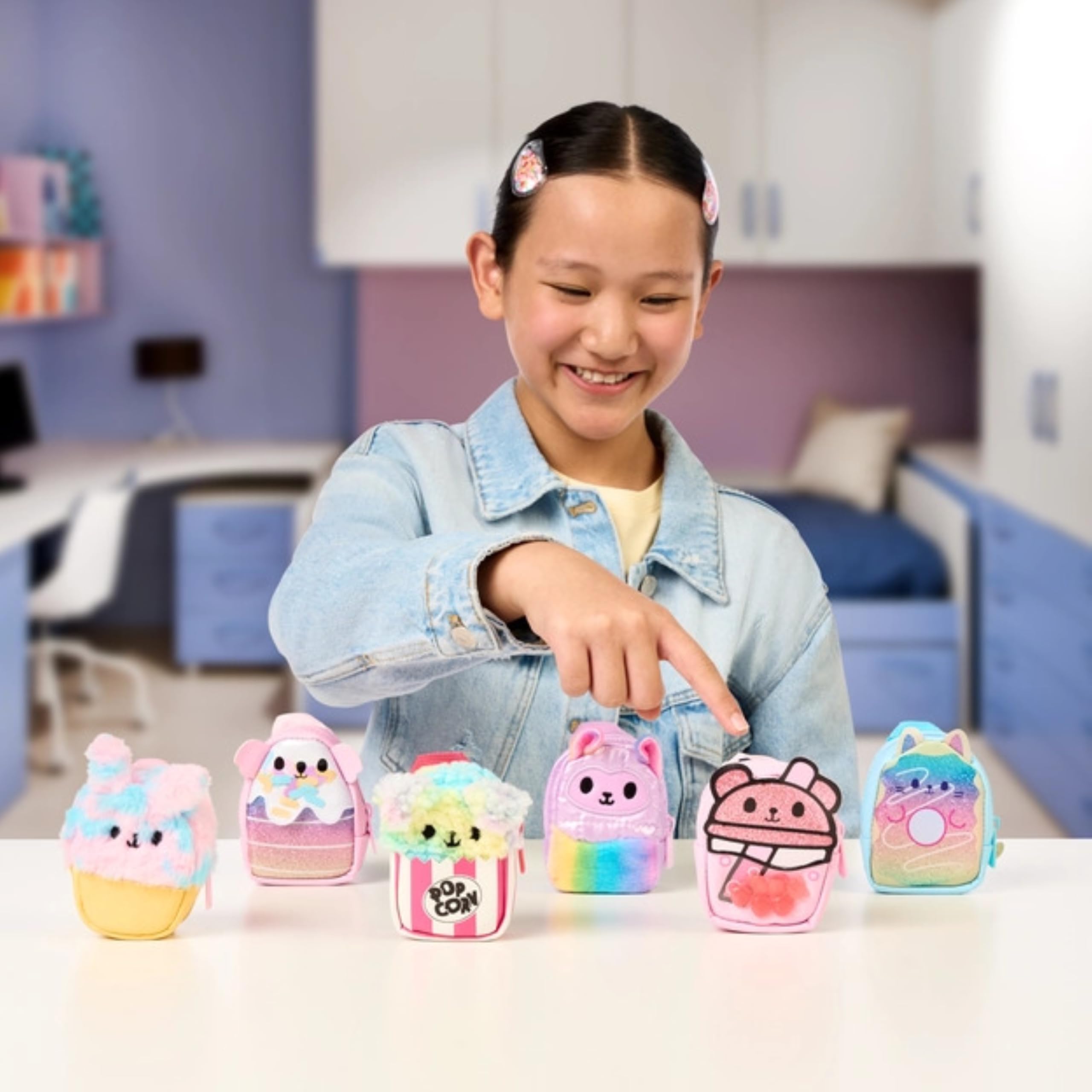 REAL LITTLES Rainbow Pupcorn backpack shows scented mini surprises for on-the-go fun.