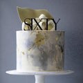 Remax acrylic Sixty topper on cake, creates elegant centerpiece for milestone birthday
