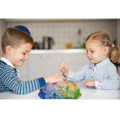 Rite Lite Dreidel Pop and Spin game pieces shown in four colors.