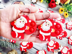 Roaqua soft silicone Santa Claus pop keychain with bright colors for focus.