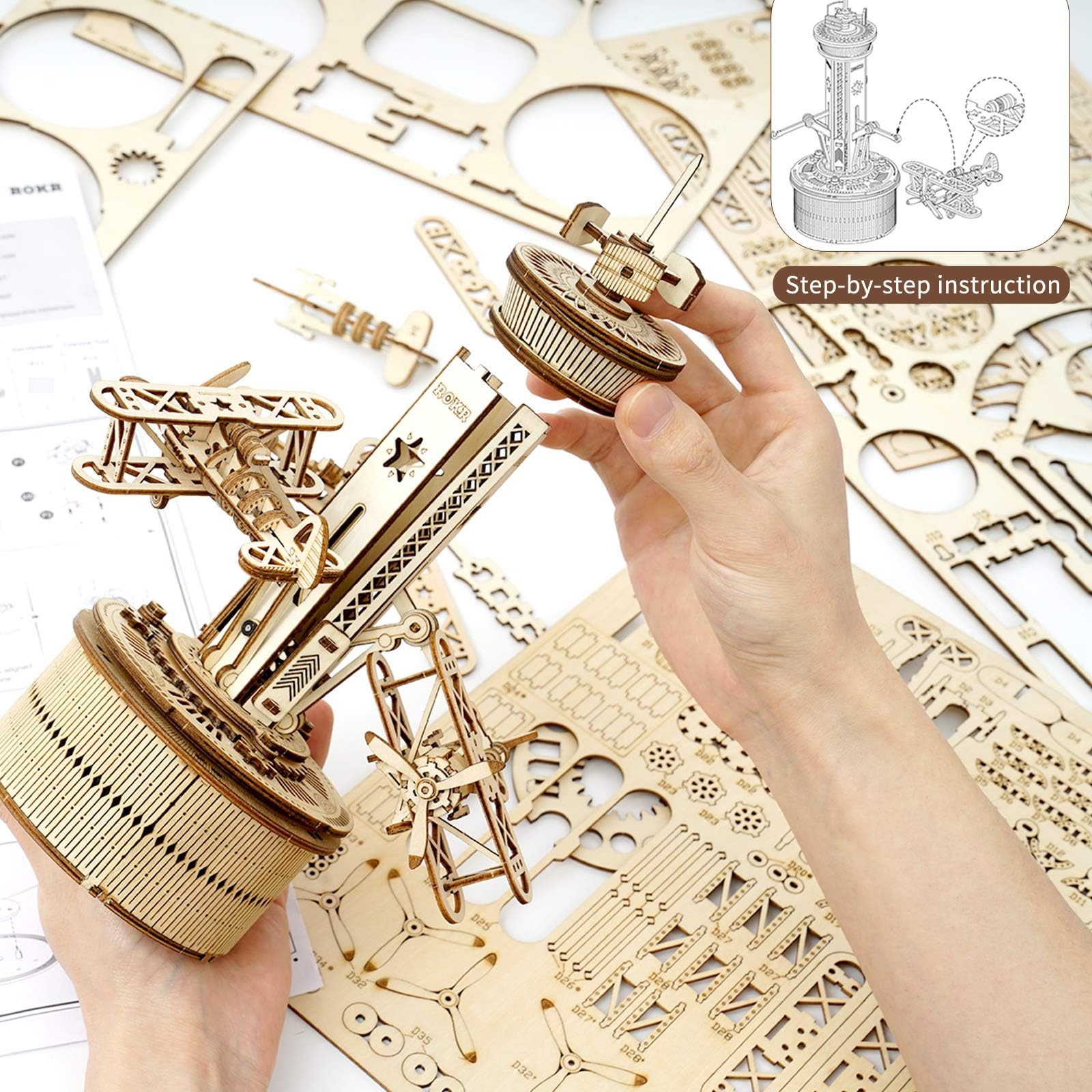 ROKR airplane tower music box parts kit shows laser-cut sheets and pre-cut pieces