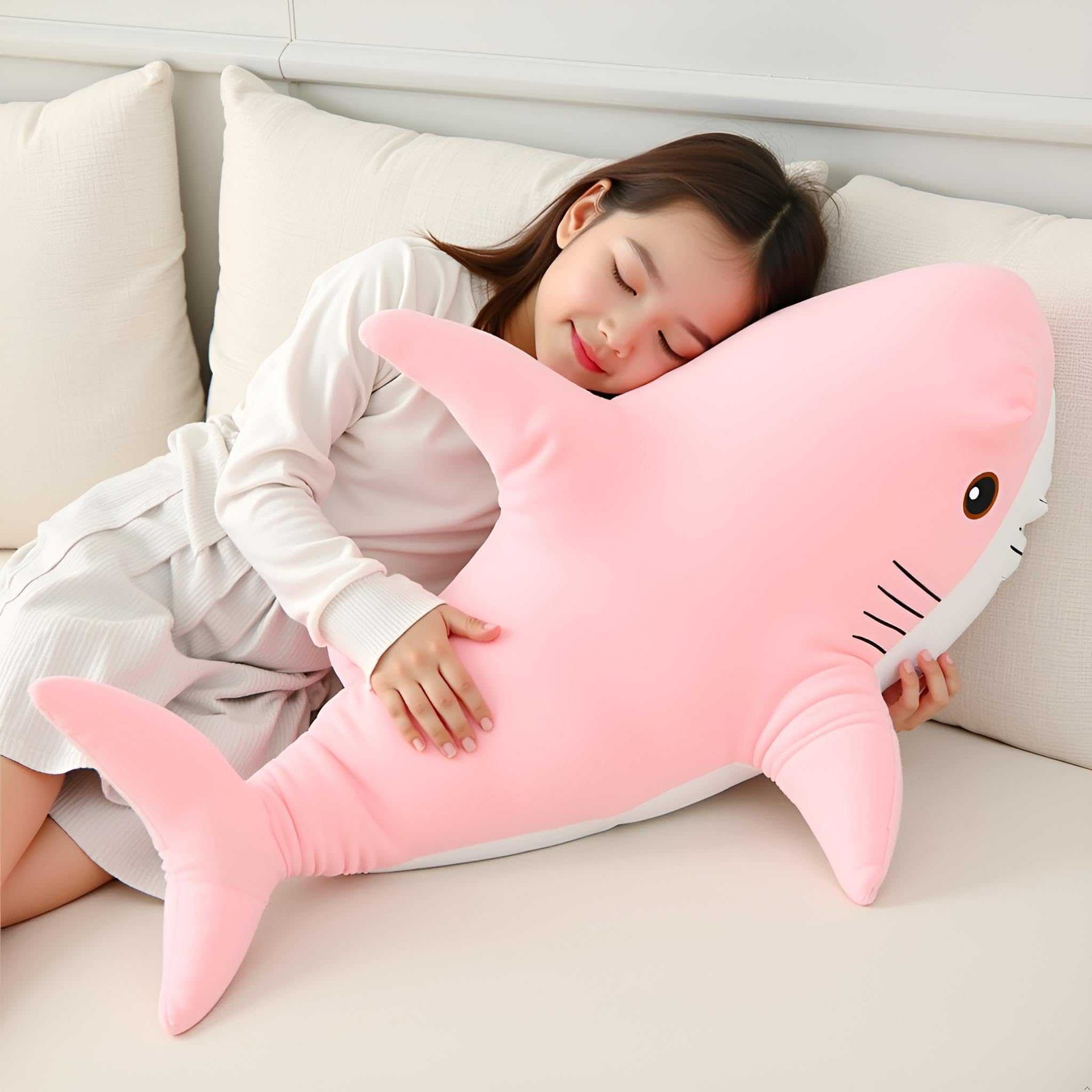 Ryttir giant shark plush as a bedtime cuddle companion on a bed.