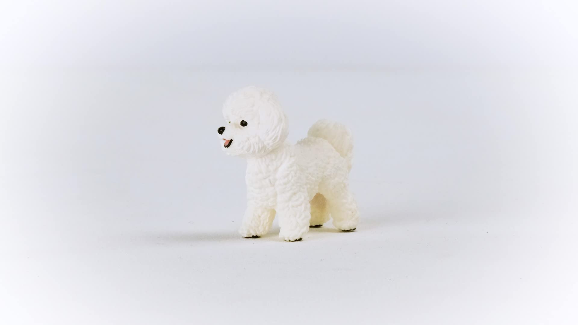 Schleich Farm World Bichon Frise figurine in a playful farm scene to spark storytelling.