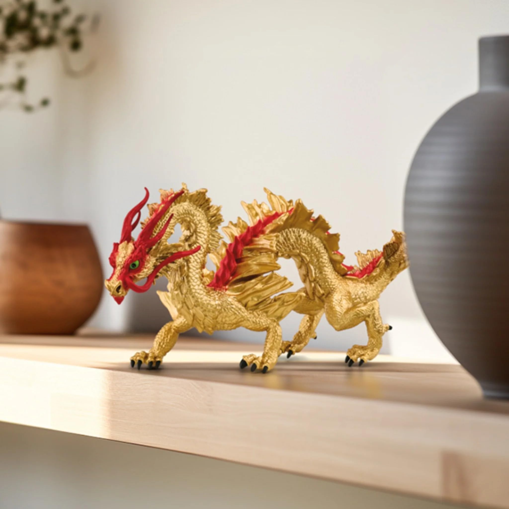 Schleich dragon figure features fiery red spines and textured surface for lifelike presence.