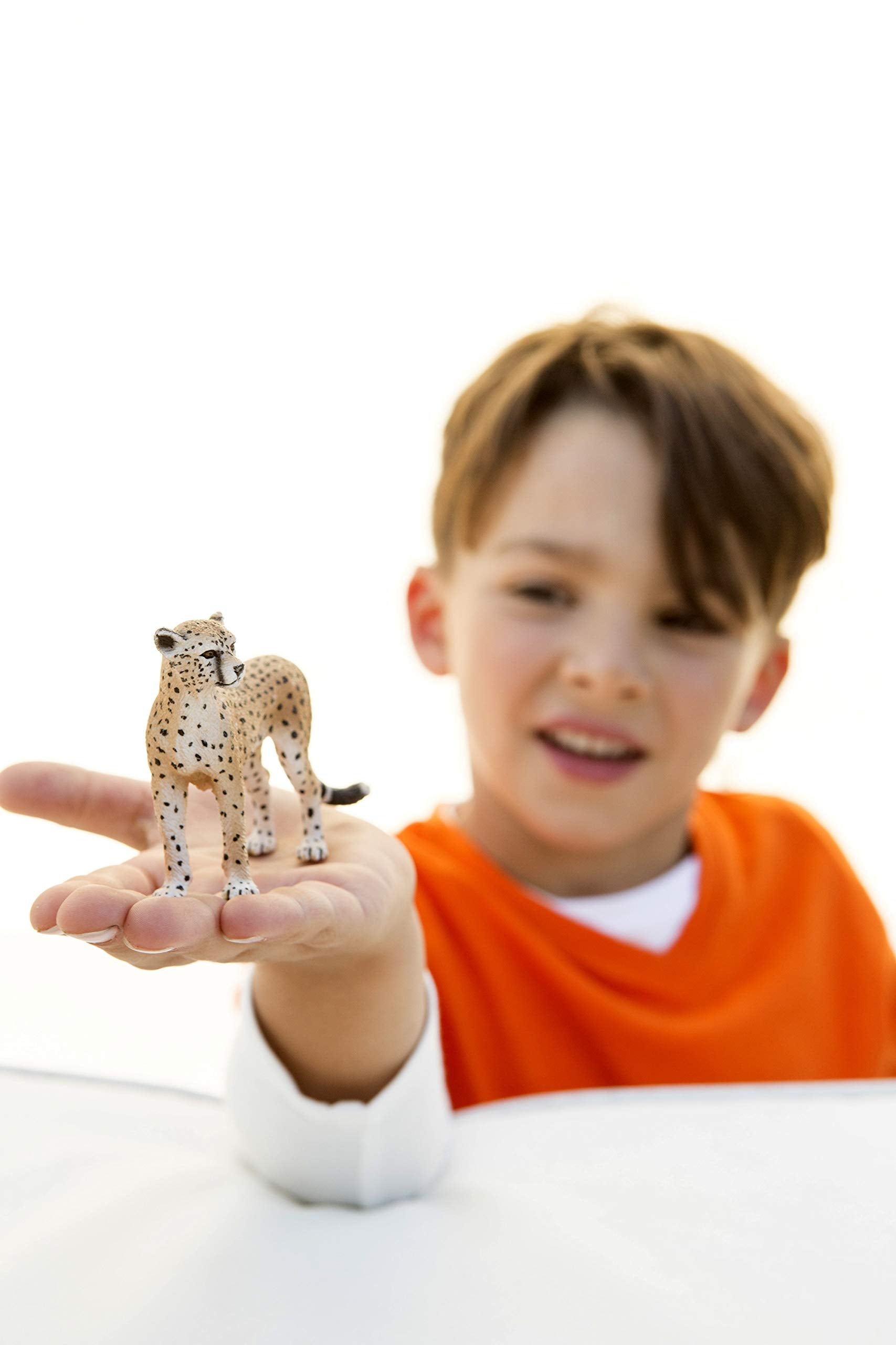 Closeup of Schleich Wild Life cheetah figurine showcasing detailed sculpting and pose.
