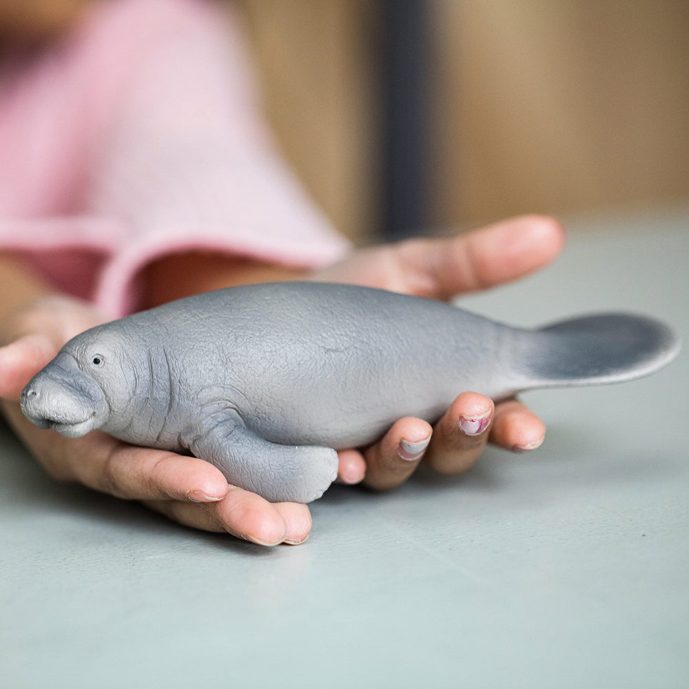 Schleich Wild Life manatee figurine in hand supports portable, hands-on learning about marine life.