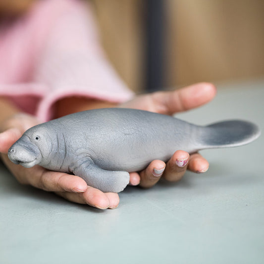 Schleich Wild Life manatee figurine in hand supports portable, hands-on learning about marine life.