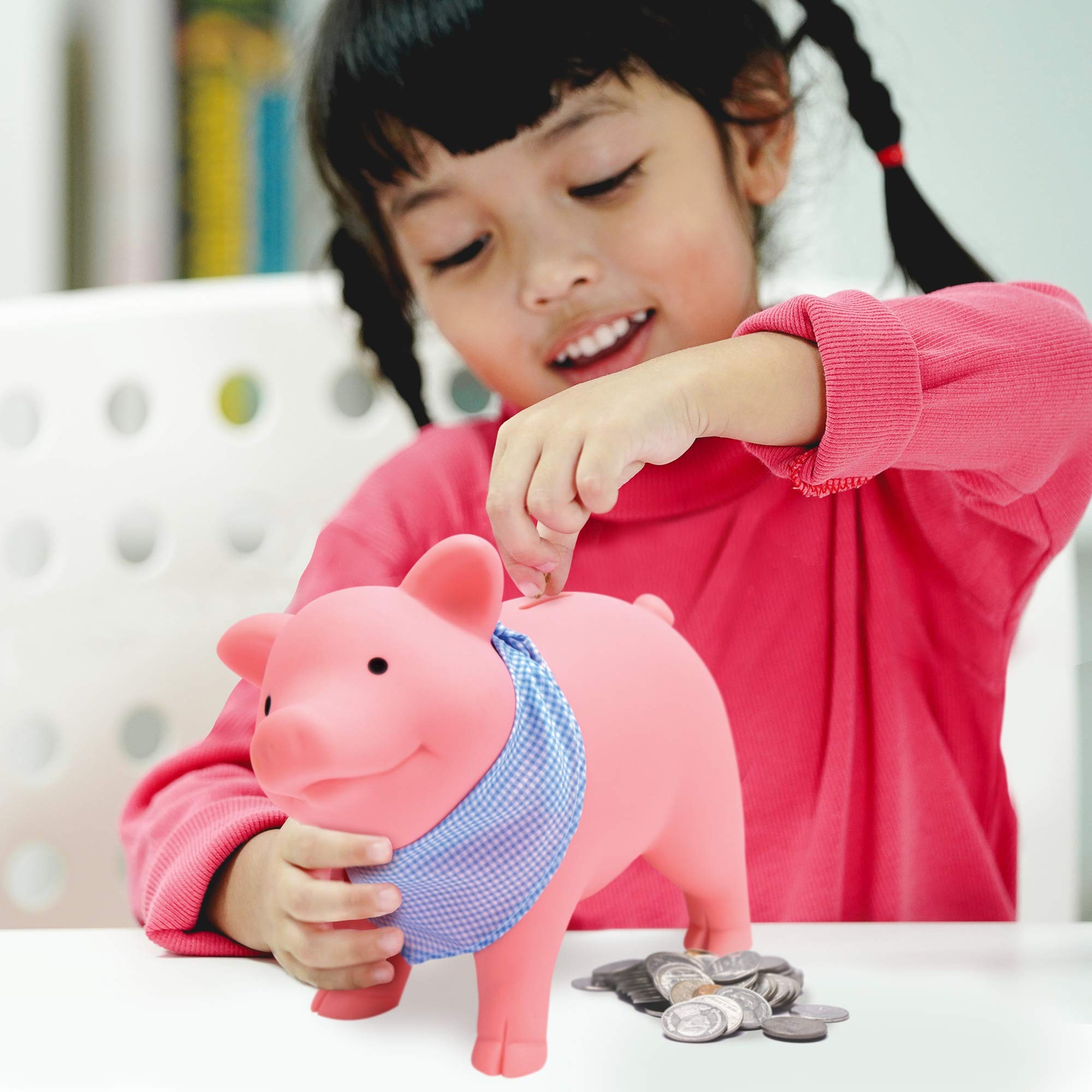 Schylling pink piggy bank showing back slot for coins.