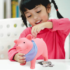 Schylling pink piggy bank showing back slot for coins.