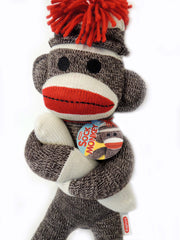 Schylling sock monkey red pompom hat detail highlighting retro charm and playful style.