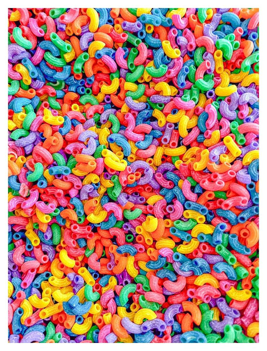 Sensory-N-Stuff rainbow elbow pasta in a bin for colorful sensory play.