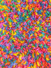 Sensory play with Sensory-N-Stuff rainbow elbow pasta in a textured tray.