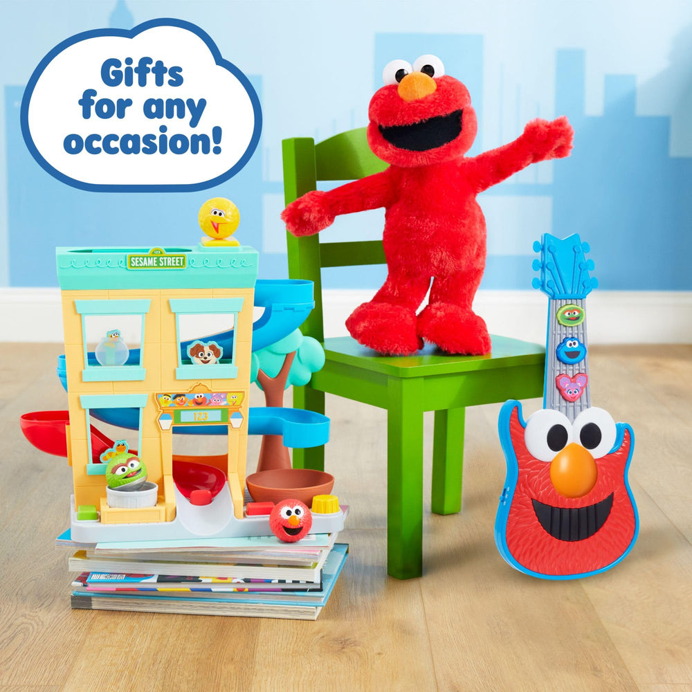 Kids pretending with Elmo guitar during a pretend jam.