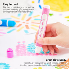 Child hands holding Shuttle Art Shimmer Dot Markers for easy grip.