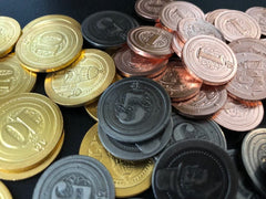 Sleeve Kings industrial coins on display, enhancing game immersion with durable, heavy metal visuals.