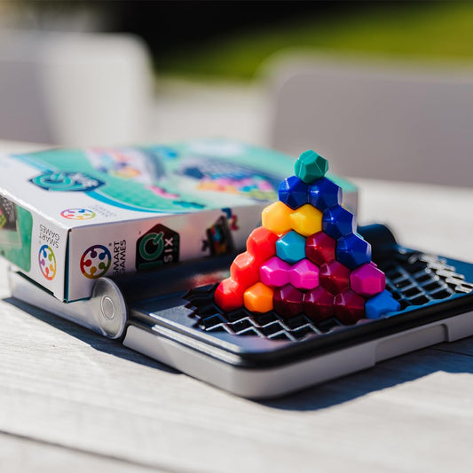 SmartGames IQ Six Pro compact game board with transparent lid for easy travel.