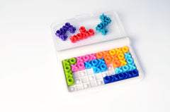 SmartGames IQ XOXO on-the-go puzzle in a compact setup for travel.