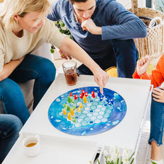 SmartGames Penguins Leader figure on ice tiles enables protective huddle play.