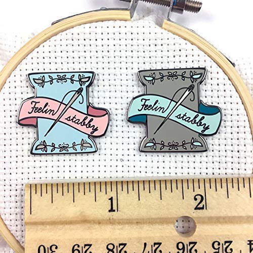Detail of Snarky Crafter enamel artistry on needle minder with spool motif