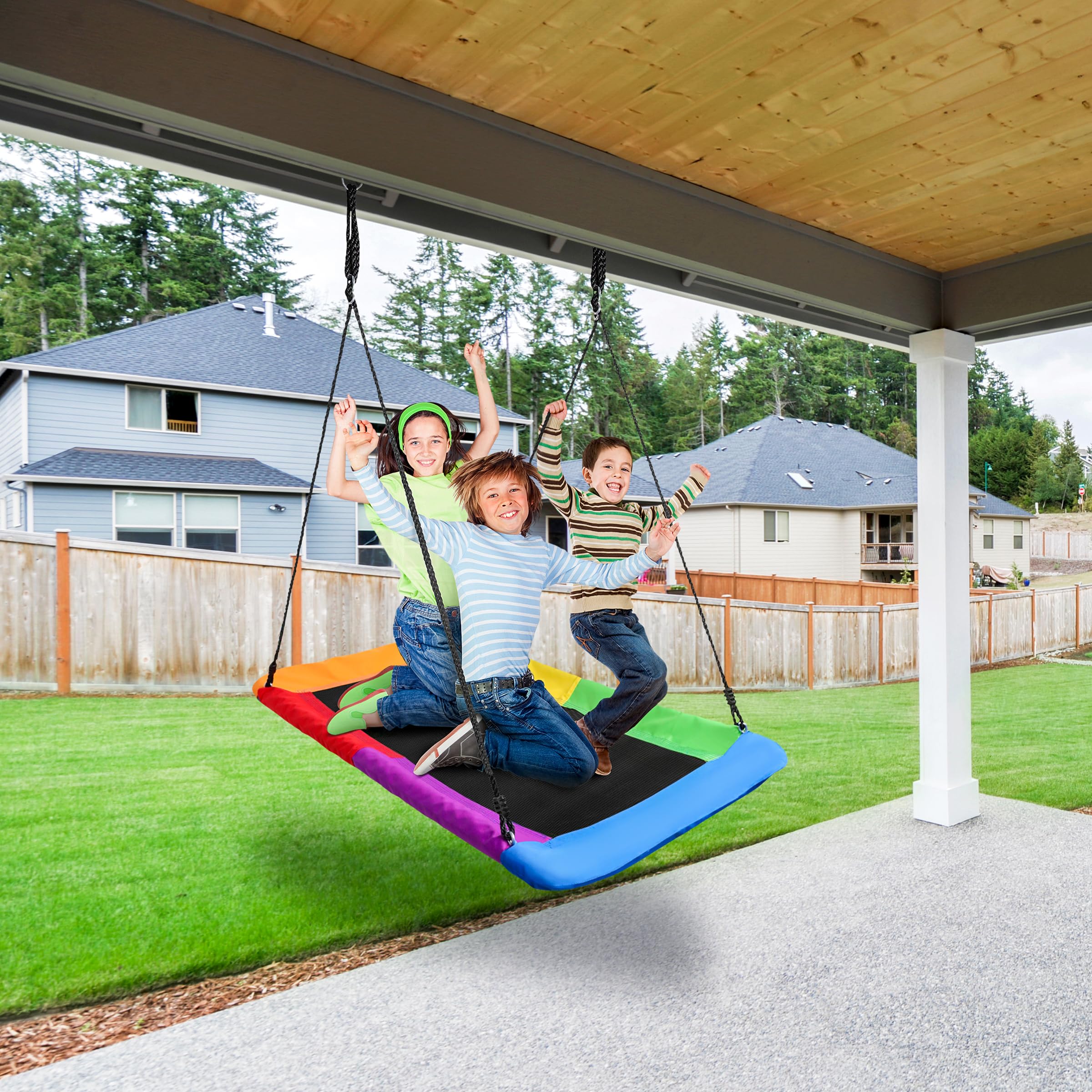 Kids enjoying Sorbus saucer swing in backyard playground.