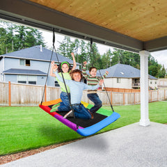 Kids enjoying Sorbus saucer swing in backyard playground.