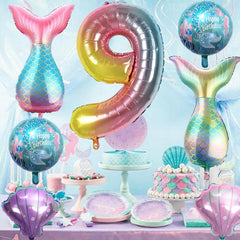 Sowide teal mermaid tail balloon adds coastal whimsy to the setup.