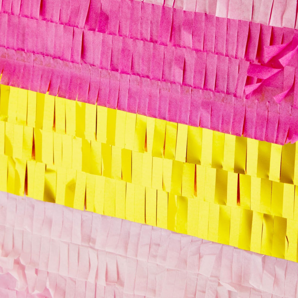 Sparkle and Bash pinata hanging closeup showing pink-gold ombre details.
