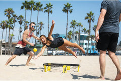 Beach play with Spikeball set illustrates sand-friendly practice.