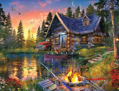 Springbok Sun Kissed Cabin puzzle shows lake view with sunset hues for a relaxing family activity.