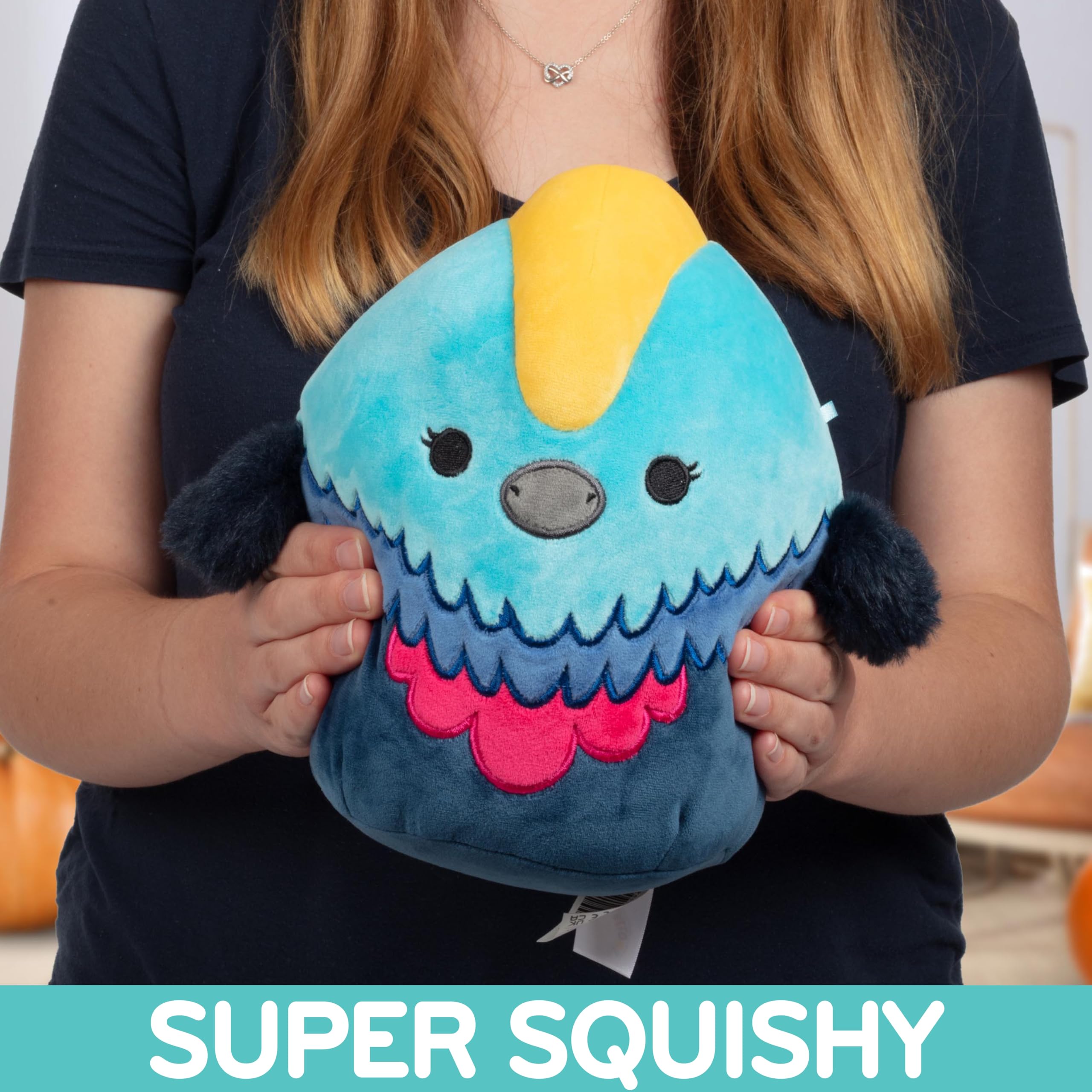 Squishmallows Melrose Cassowary in hand, perfect travel buddy on car rides.