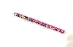 Star Magic mini wand close-up highlights swirling glitter in light.