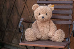 Steiff Jimmy Teddy Bear face with inquisitive eyes inspires imaginative playtime.