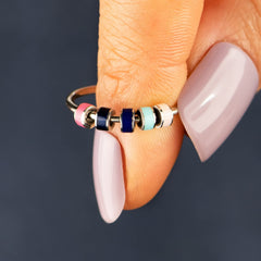 STORYJEWELLERY Fidget ring on finger for discreet calm moments.