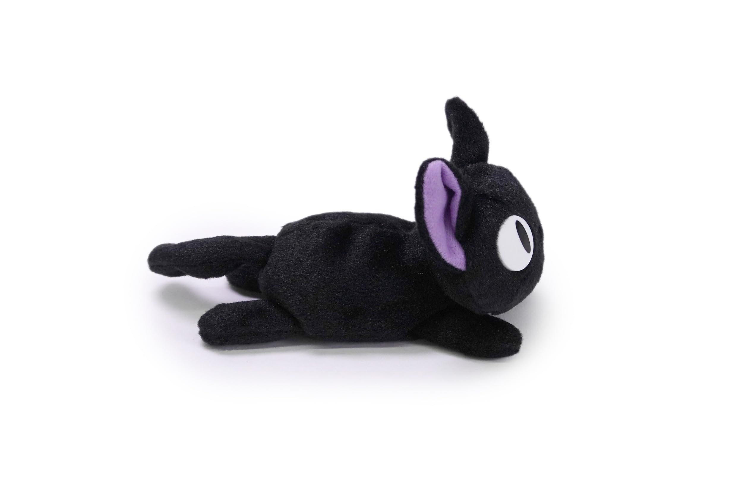 Jiji plush resting in a kid-friendly reading nook for cozy moments