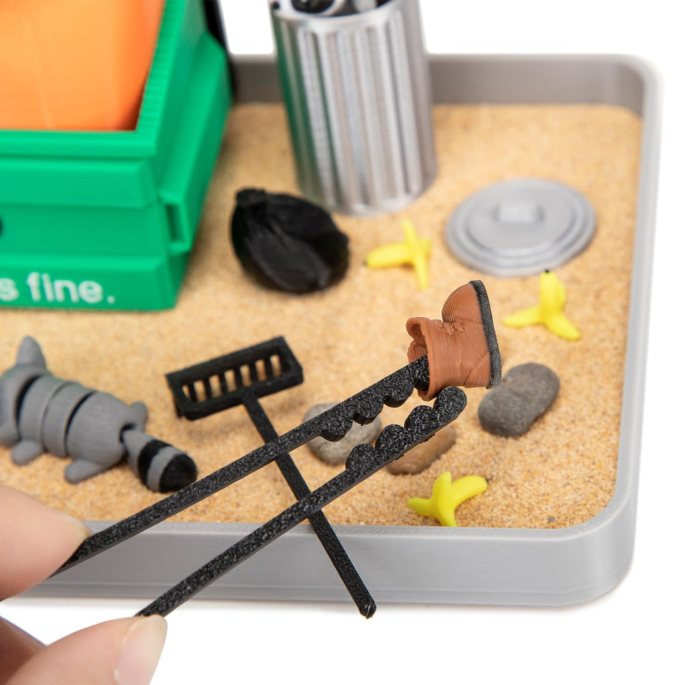 Stylor kit includes stones, sand, and accessories for sensory play.