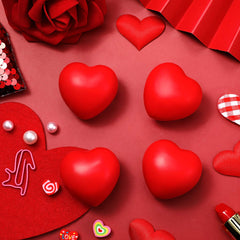 Sumind red heart stress ball in hand, portable fidget toy for focus and calm.