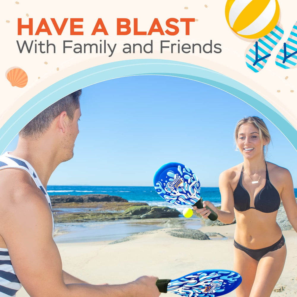 Sunlite Sports blue paddle set contrasts vividly with sand and grass.